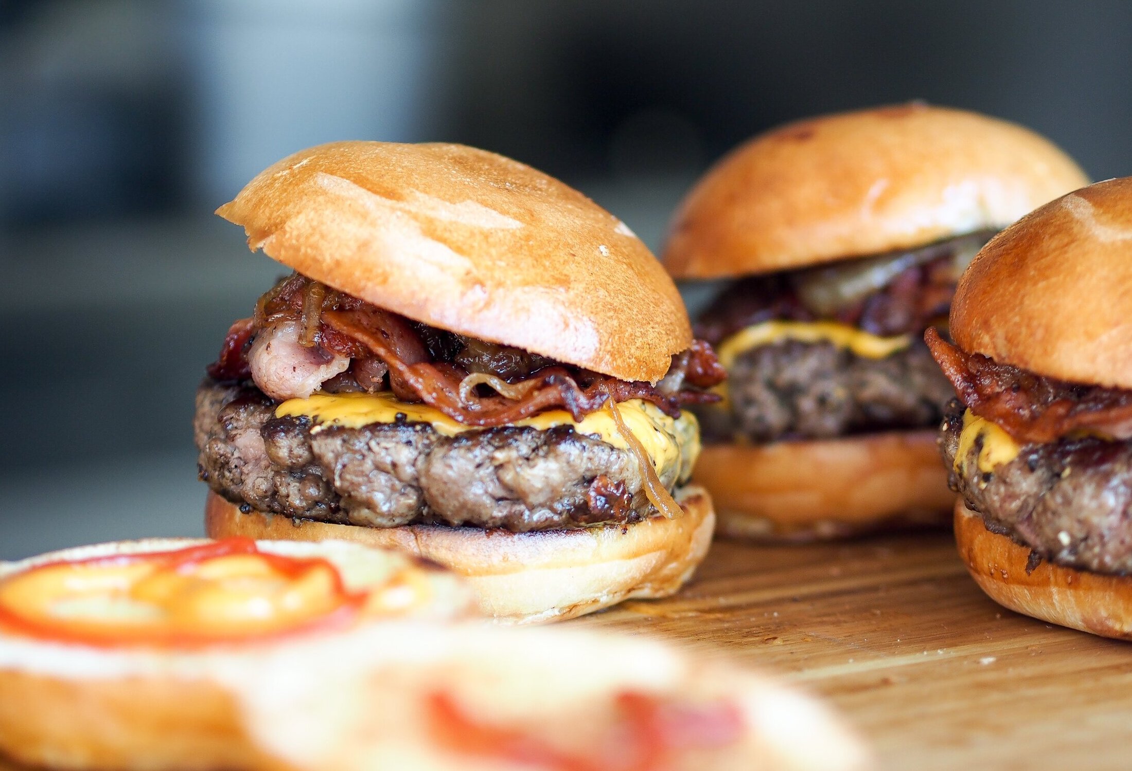 Cheeseburgers on wood cutting board